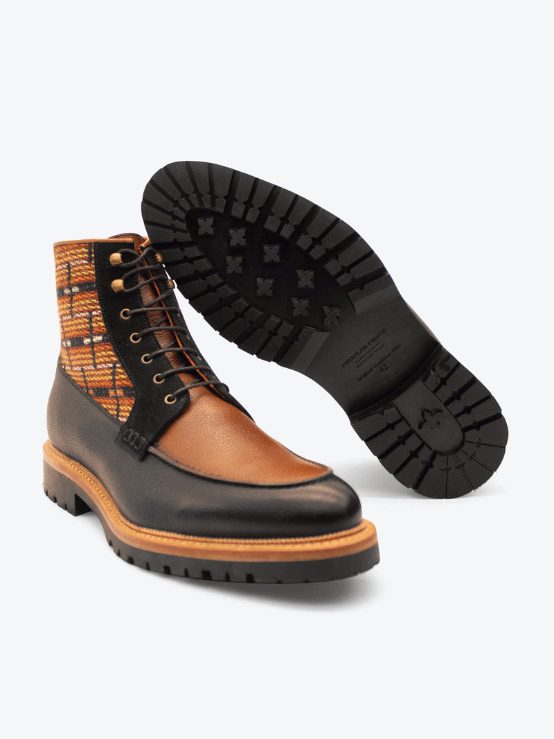 Three quater and bottom view of limited edition Brooklyn 1997 Symmetry Moc Boot. Handcrafted jacquard cloth with luxurious Italian suede, fullgrain black and cognac leather, lasted on our commando sole using the Goodyear method with storm welt