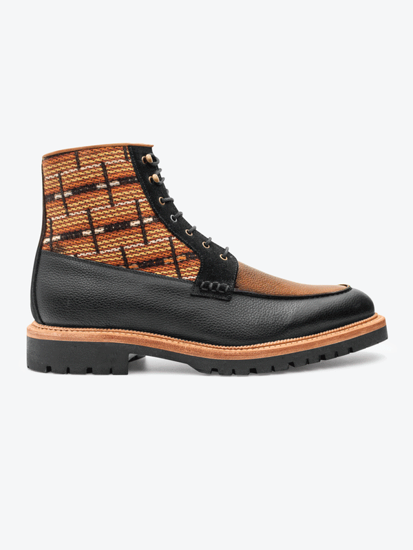 Side view of limited edition Brooklyn 1997 Symmetry Moc Boot. Handcrafted jacquard cloth with luxurious Italian suede, fullgrain black and cognac leather, lasted on our commando sole using the Goodyear method with storm welt
